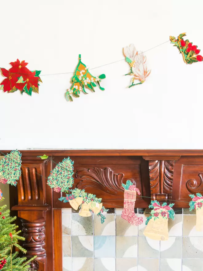 Christmas set up with garland hanging over fireplace