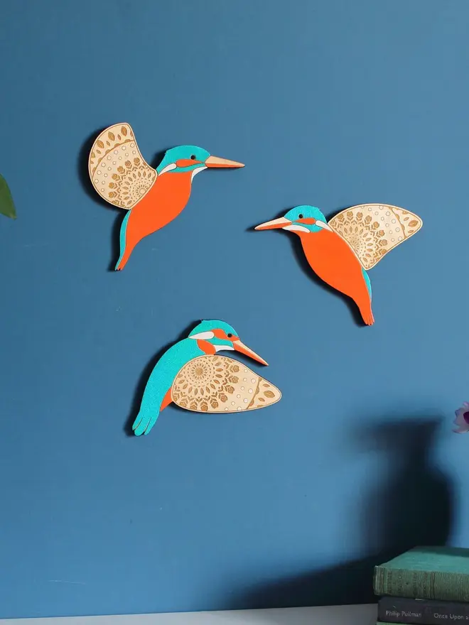 Folk Art Wooden Kingfishers (Set Of 3), wooden kingfishers hanging flying on a wall. 
