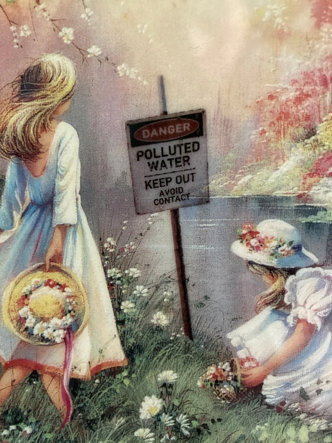 Beautiful decorative 8” plate featuring a watercolour style image of two young girls playing by a river. On the other side of the river is a beautiful white house. The scene is idyllic, yet in the river we see a warning sign which says ‘Danger! Polluted Water’...