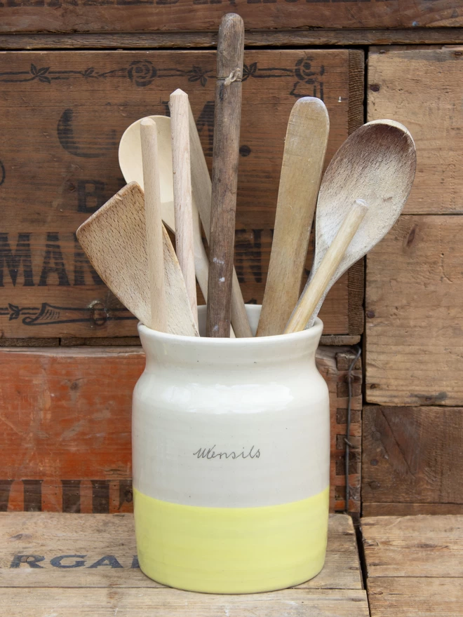 Utensil pot with vintage wooden spoonsa