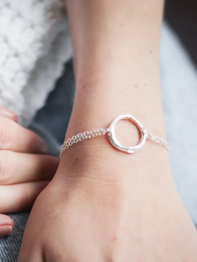 A woman wearing a Silver Organic Circle Bracelet 