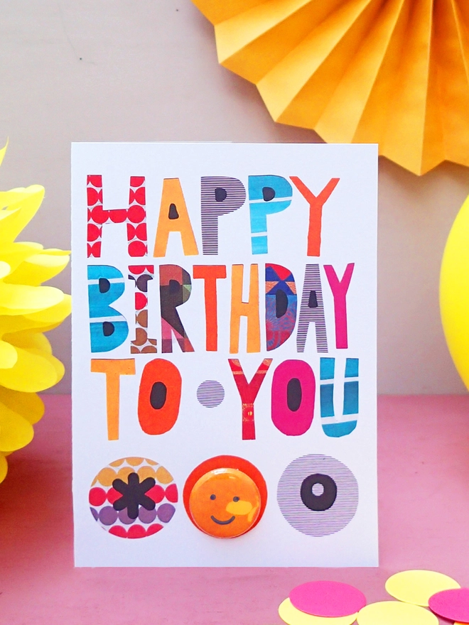 Colour and pattern greeting birthday card with oin badge