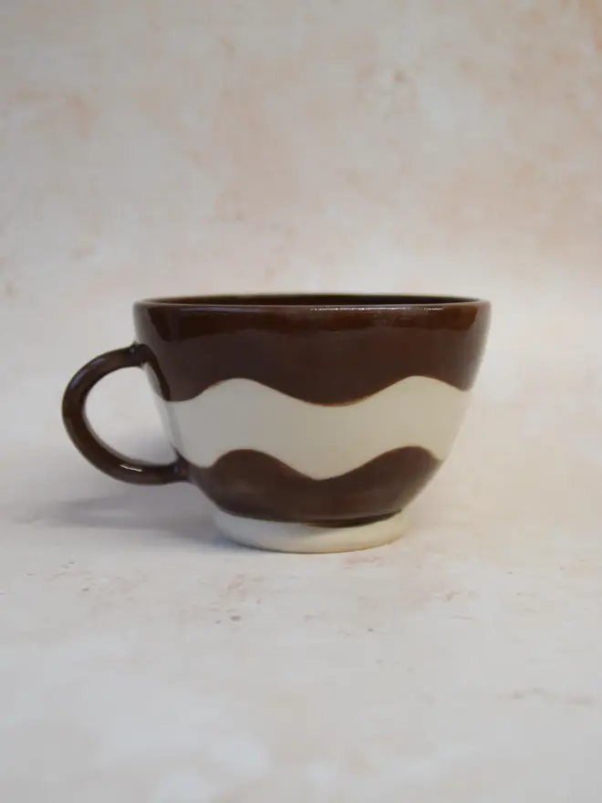Handmade ceramic Ripple Mug — brown and cream wavy pattern, side view