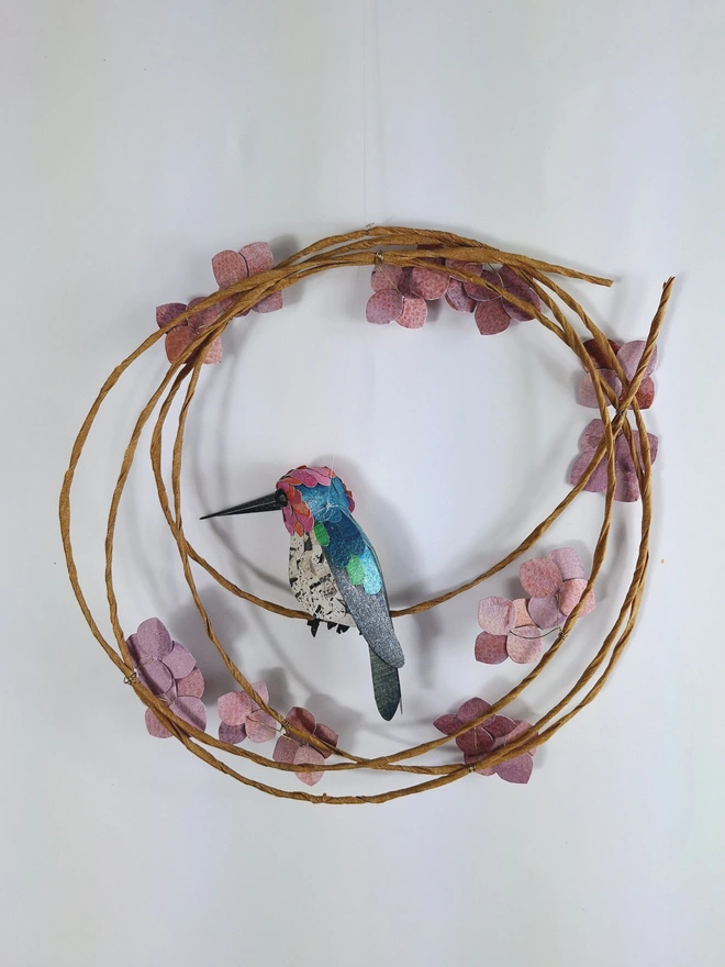 back view of a pink hummingbird wall art