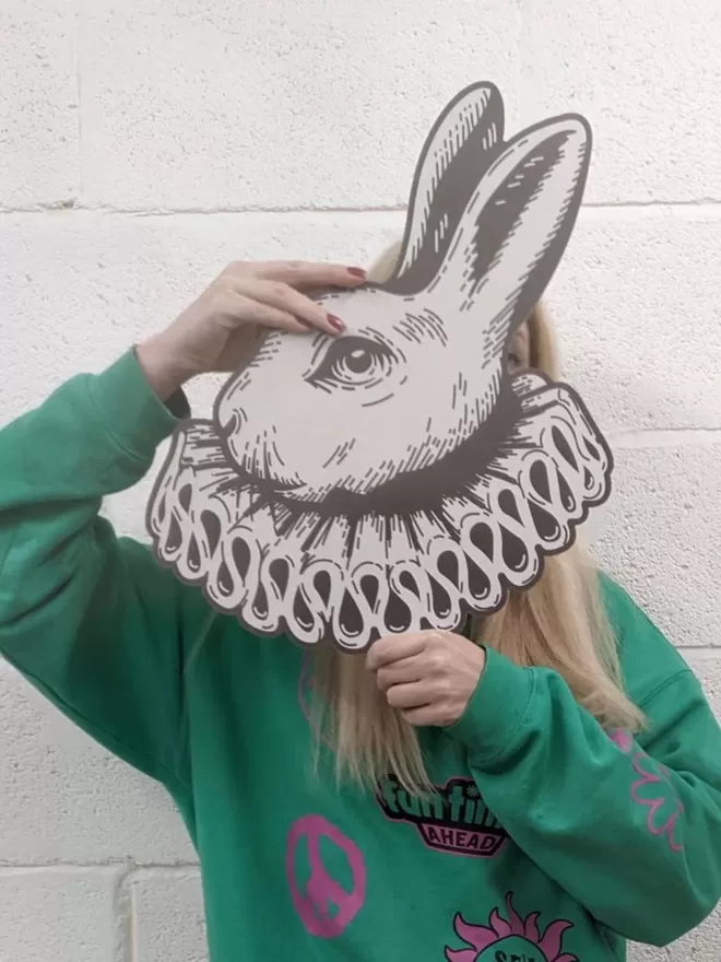 White Rabbit head seen held up by a woman.