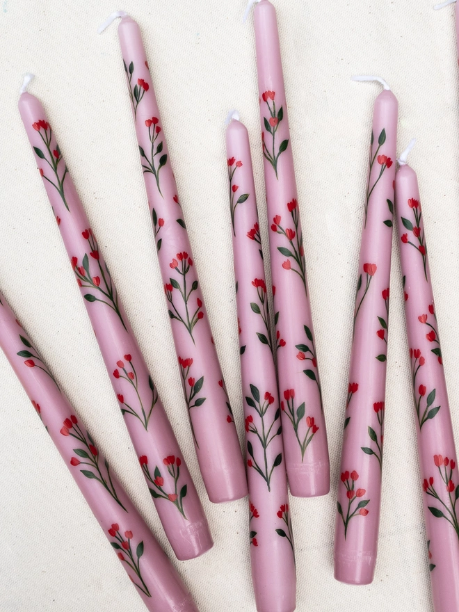 Pink taper candles hand painted with wildflower blossoms. 