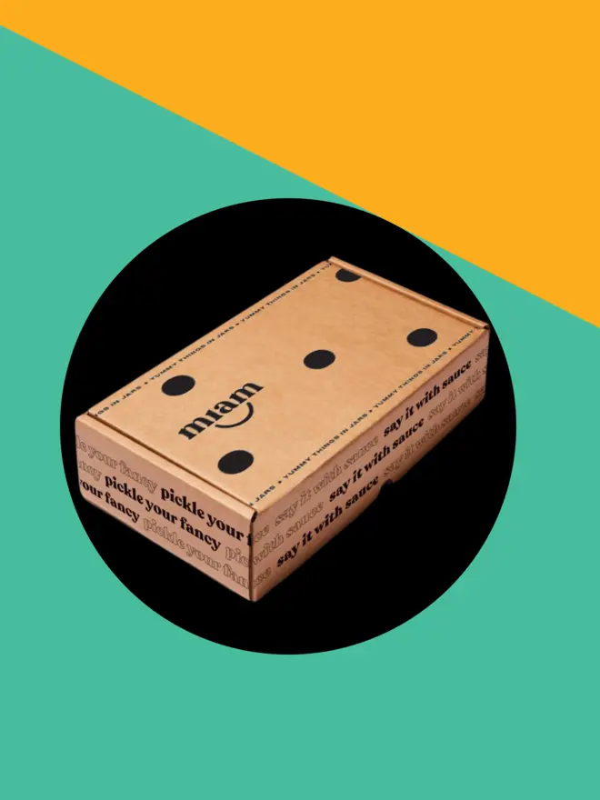 giftbox on an orange and teal background with a black circle