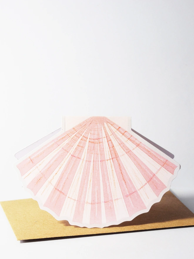 A cut out card of a scallop shell