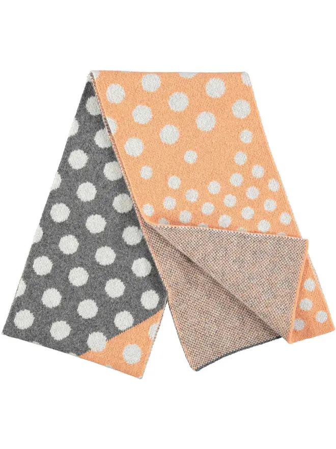Lambswool Striped Scarf, a colourful striped scarf sitting on a plain white surface. 