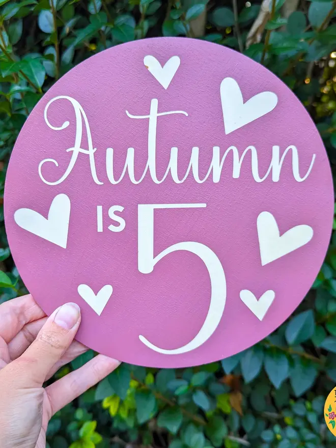 personalised wooden birthday sign. a purple round wooden sign with a personalised birthday message.