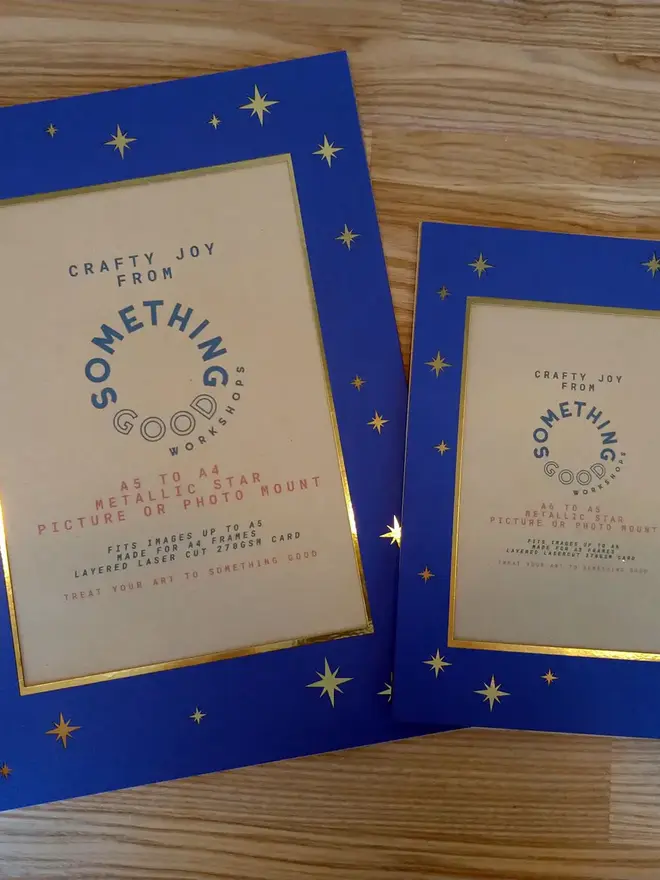 metallic star a5 / a4 christmas photo mount. a5 and a4 mounts pictured on wooden background.