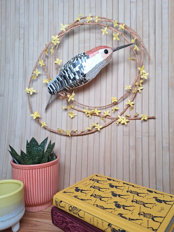 Forsythia flower wreath featuring an orange bellied woodpecker sculpture