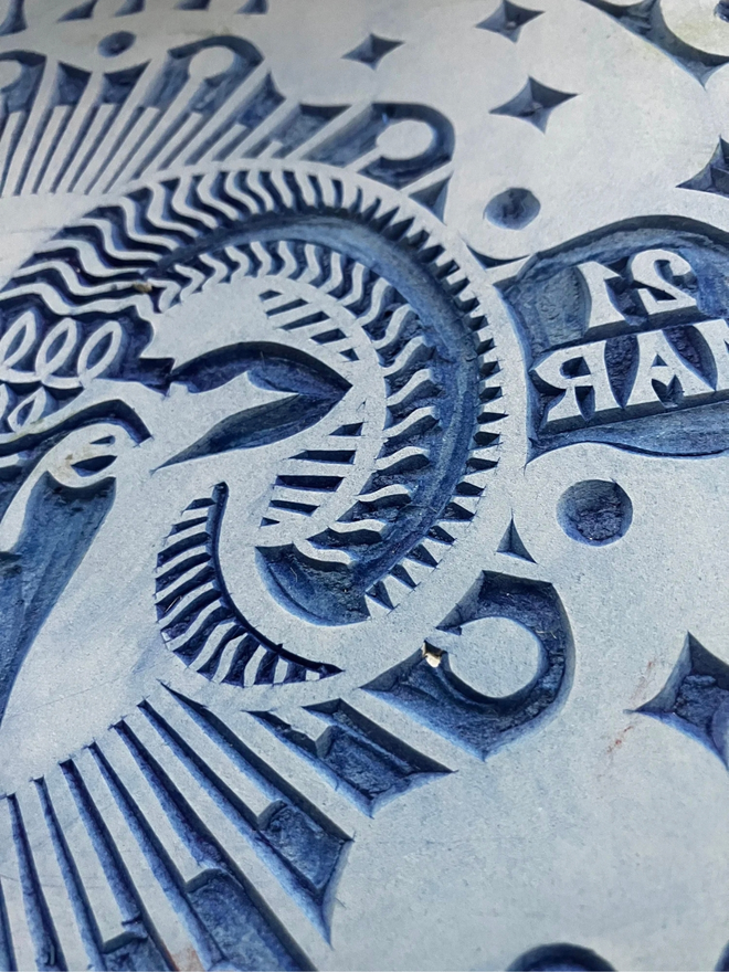 aries zodiac linocut. a ram and zodiac signs linocut and printed on a blue background.