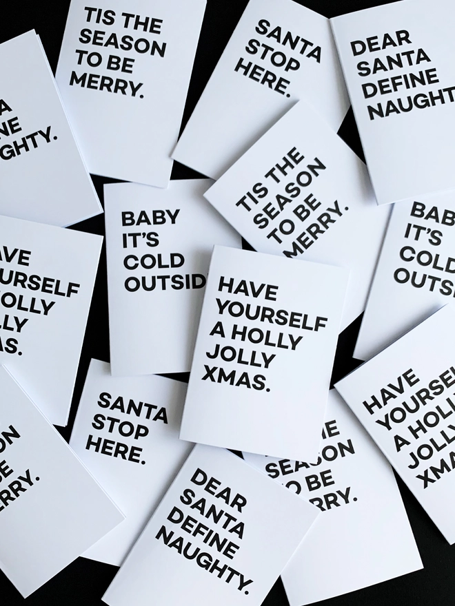 Group of black and white Christmas Cards with festive phrases