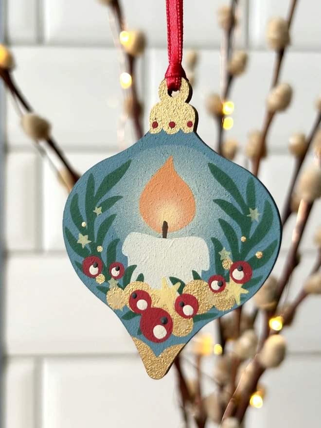 Laser cut wooden bauble shapes which have been hand painted with one christmas candle design and one with a festive bell design. Using blue, yellow, green, red and gold paint.