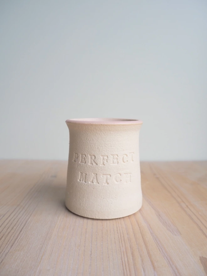 Perfect Match stoneware pot, no matches. Showing pale pink glaze on the rim