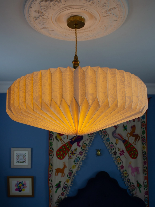 White origami lightshade hanging from ceiling 