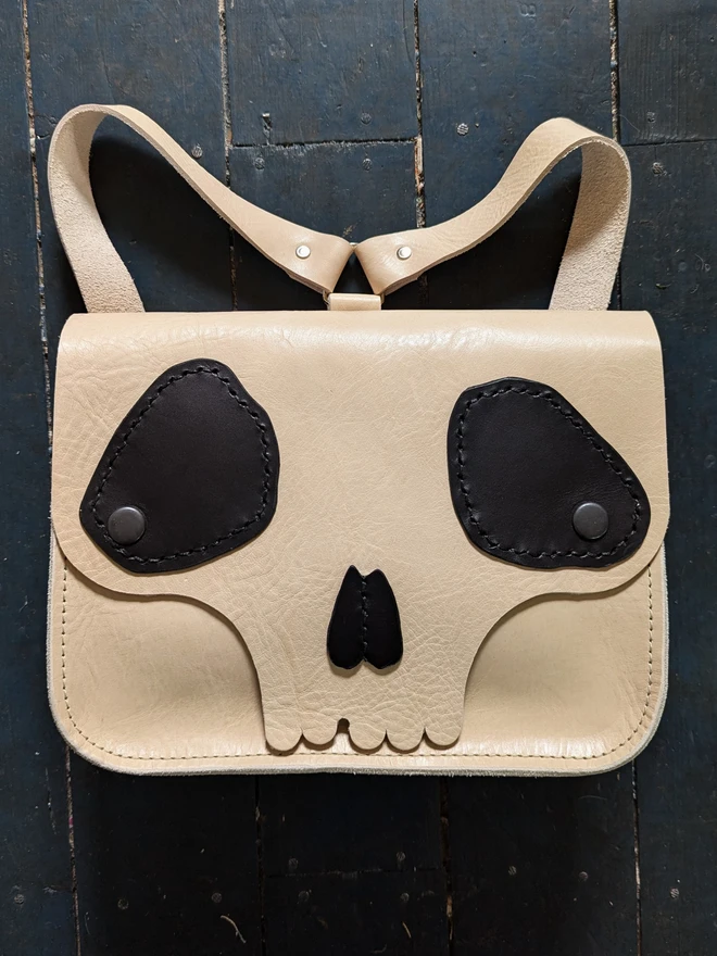 Cream and black leather skull backpack front view