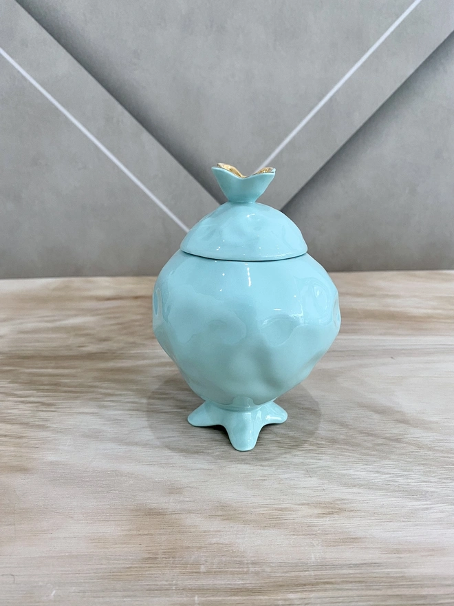 Mint green sugar bowl in a shape of pomme granate with gold plated details.