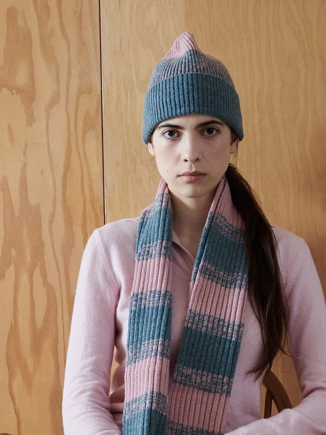 Lambswool Striped Scarf, a woman wearing a colourful striped scarf indoors. 