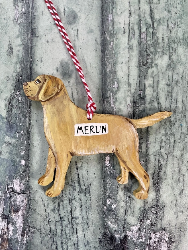 Golden Labrador Christmas Tree Decoration Hung with red and white twine and personalised with the name Merlin 