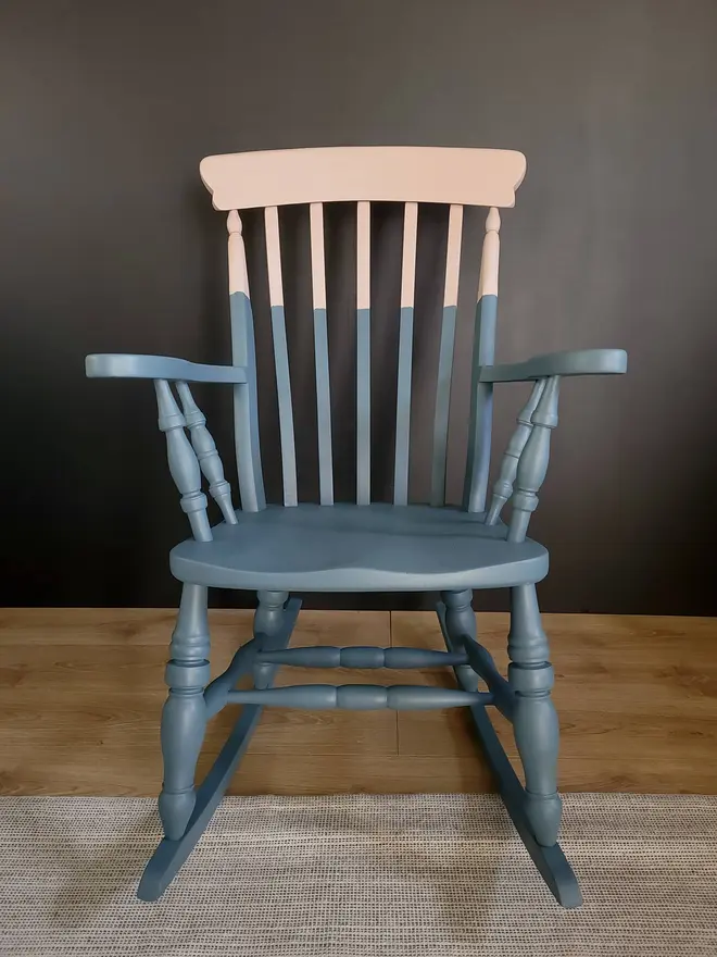 Front view of blue and pink painted wooden rocking chair