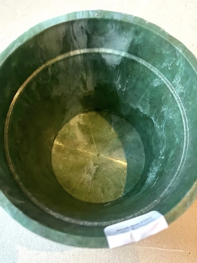 Small Green Ocean Plastic Plant Pot, a green recycled plant pot against a plain backdrop. 