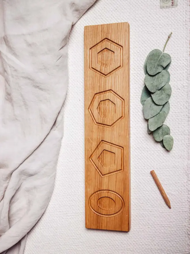 Wooden Shape Tracing Puzzle Heirloom Toy, on a table. 