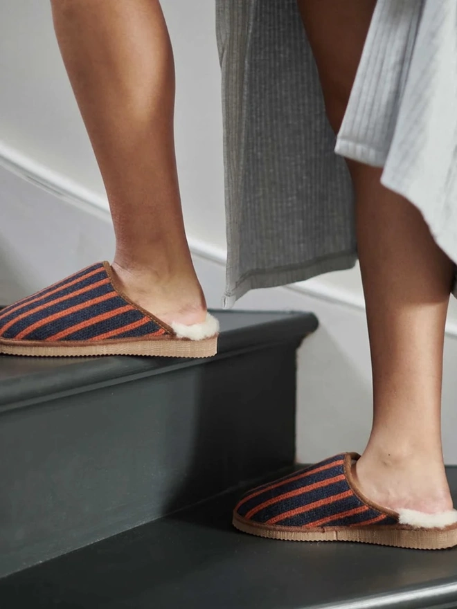 Lambswool & Sheepskin Slippers, a person wearing a pair of colourful lambswool and sheepskin slippers. 