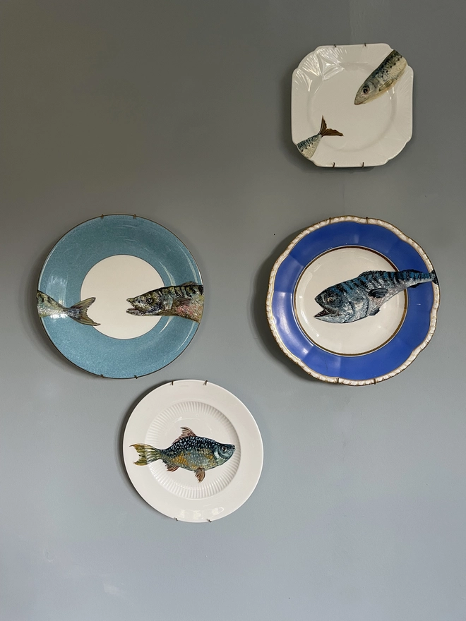 fish paintings on plates as wall display