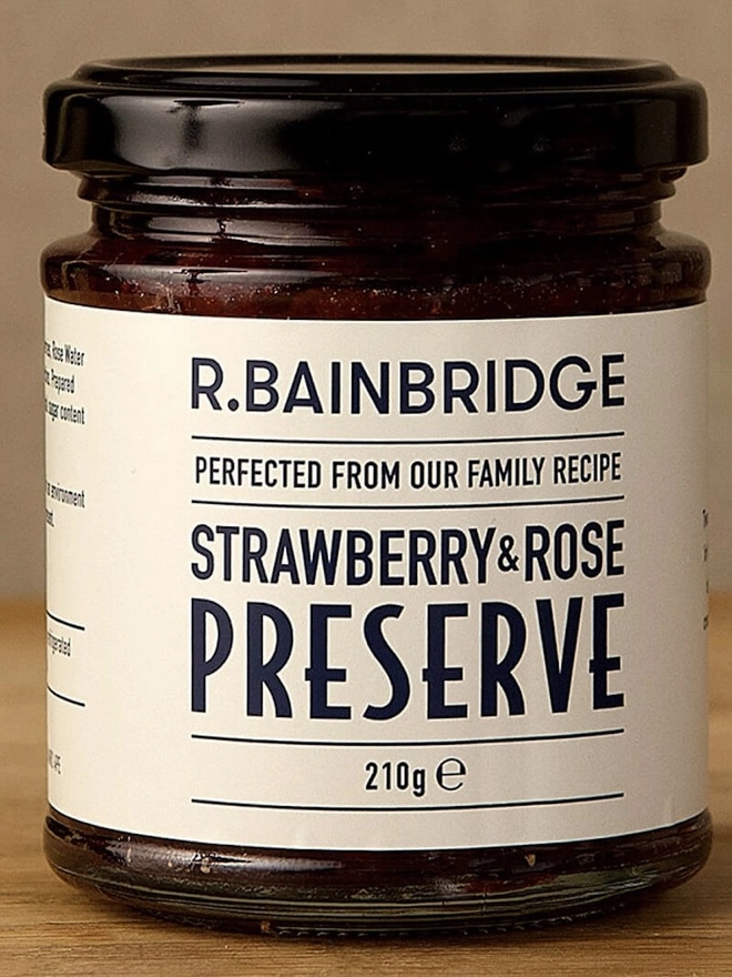 Strawberry & Rose Jam (Set Of 1, 2 Or 3), a jar of jam sitting on a wooden surface. 