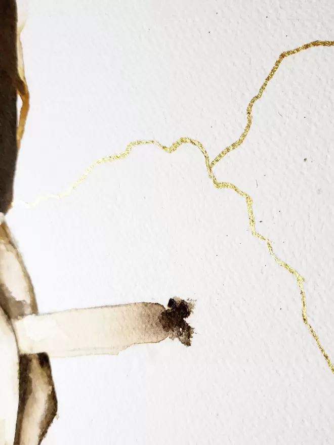This is a close up of the cigarette in the man's hand, as well as the gold leaf crack in the background.