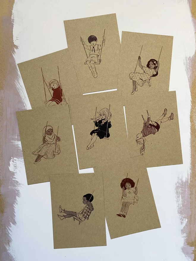 8 kraft postcards featuring drawings of children sat on swings printed in black and brown and maroon inks