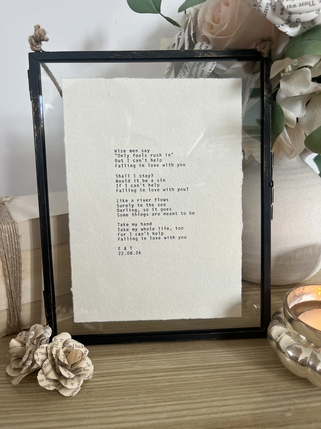 custom typewriter print framed in a rustic black hanging frame with gold brush detailing. the print is typed on cotton rag deckled paper.
