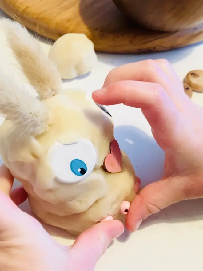 child playing with Easter bunny play dough kit
