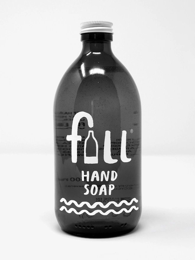black glass bottle of handsoap that reads 'fill'