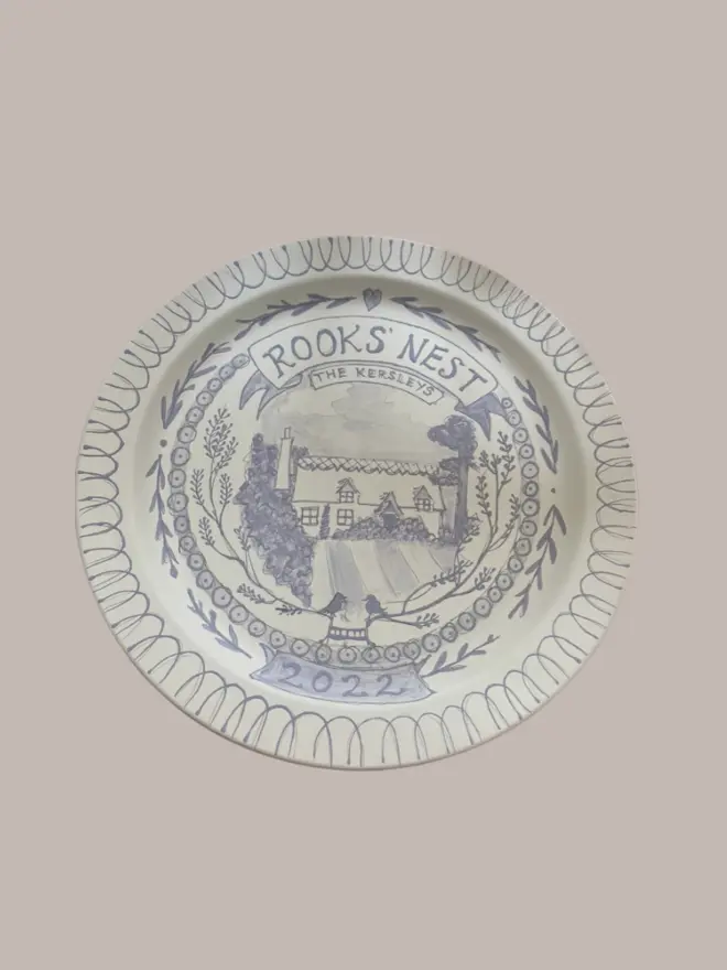 Pre-kilned hand-painted plate of a cottage in blue and white. Personalised commissions of your home.