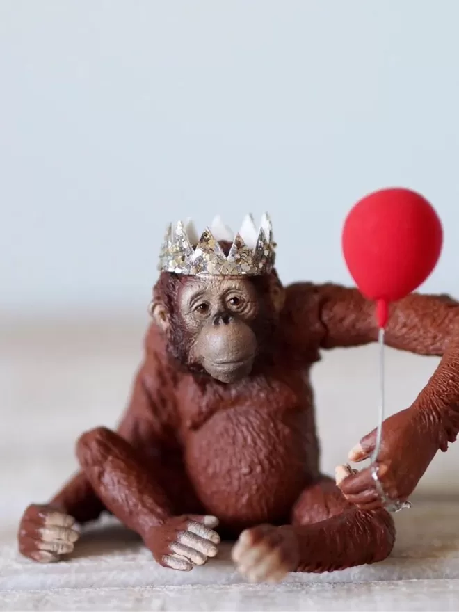 Orangutan seen with a sparkly crown.