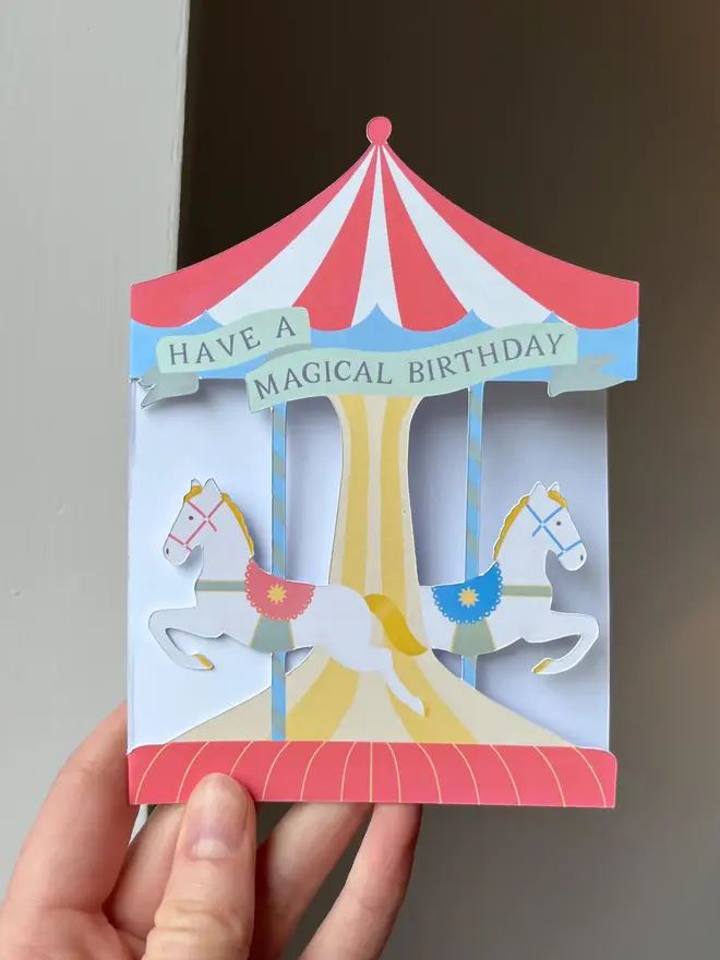 have a magical birthday carousel card. illustrated carousel cut out birthday card with horses.