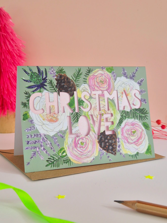 Pretty rose illustration christmas card with Christmas love paper cut text and metallic pink backing paper 