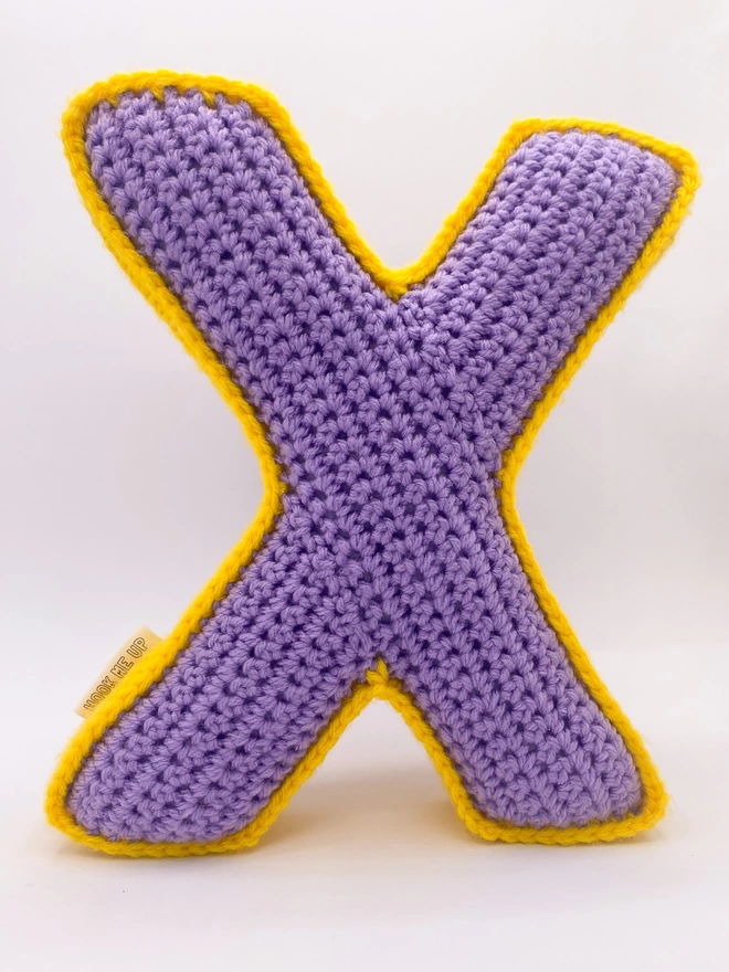 Crochet Cushion shaped like an X in Lilac and Sunshine Yellow