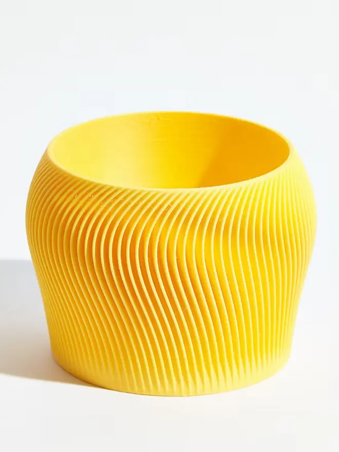 Sustainable 3D Printed Banana Yellow Plant Pot, orbital design against a white background.