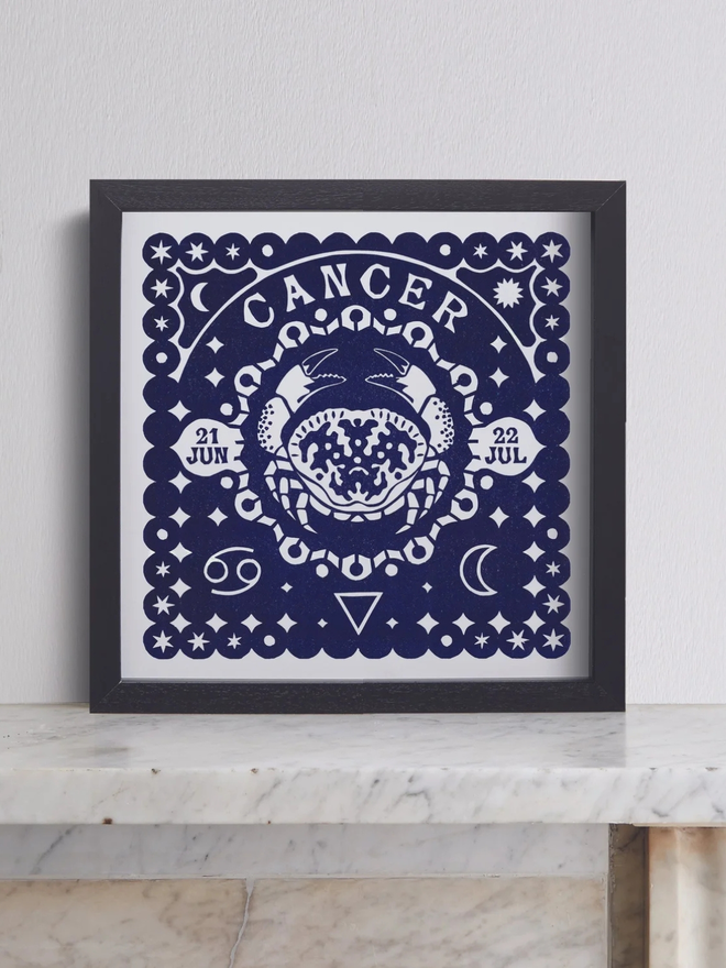 cancer zodiac linocut. a crab linocut and printed on a blue background.