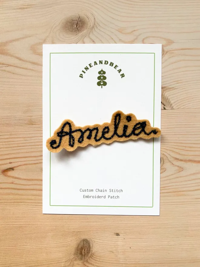 Personalised Chain Stitch name patch in biscuit and navy on a white presentation card