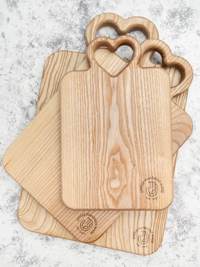 Heart Serving Boards (Set Of 3), on a marble surface. 