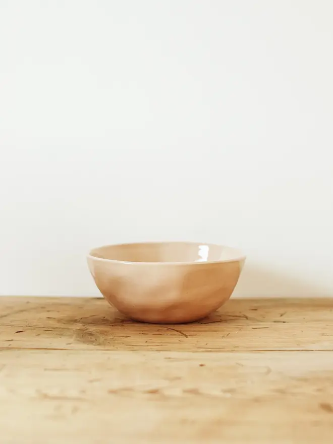stoneware place setting dining set. a pink stoneware bowl.