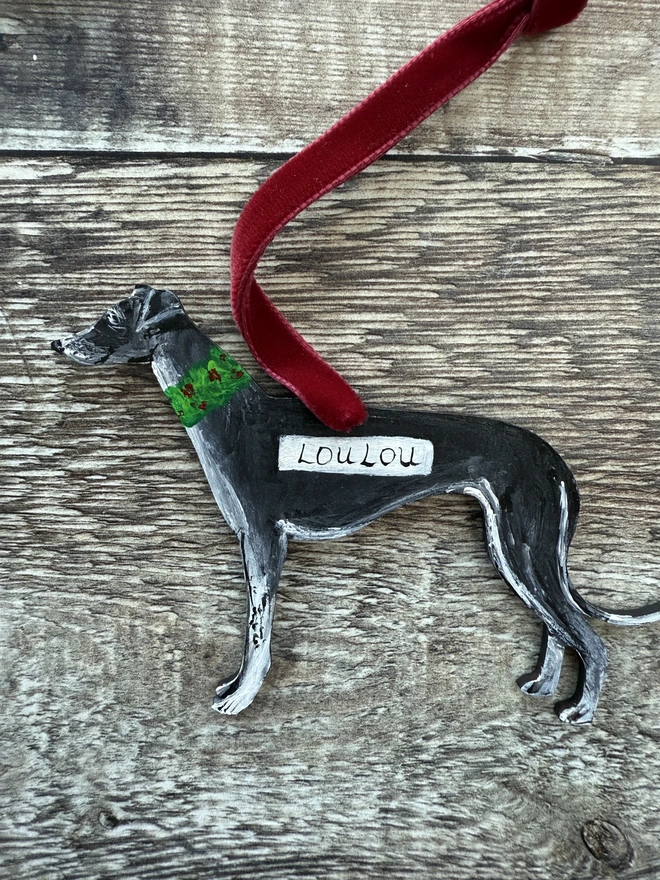 Black whippet hand - painted dog Christmas decoration strung with red ribbon