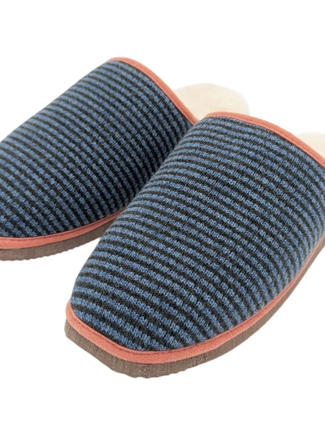 Lambswool & Sheepskin Slippers, a pair of colourful lambswool and sheepskin slippers sitting on a plain white surface. 