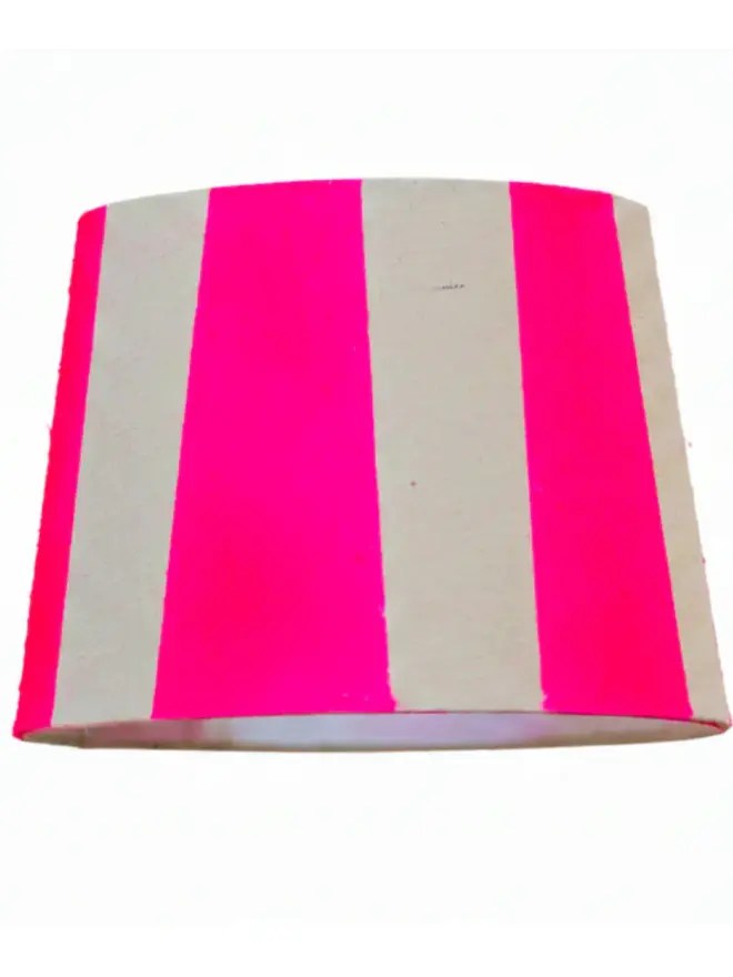 Hand Painted Upcycled Striped Sustainable Drum Lampshade, a neon pink striped lampshade against a white background. 