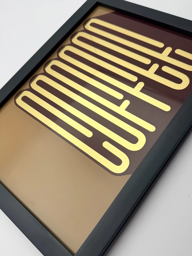 'Coffee' Gold Leaf Glass Artwork, hanging on a white background 